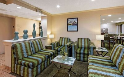 Cozy lobby seating area with comfortable furnishings, providing guests with a welcoming space to relax or meet with friends and colleagues.