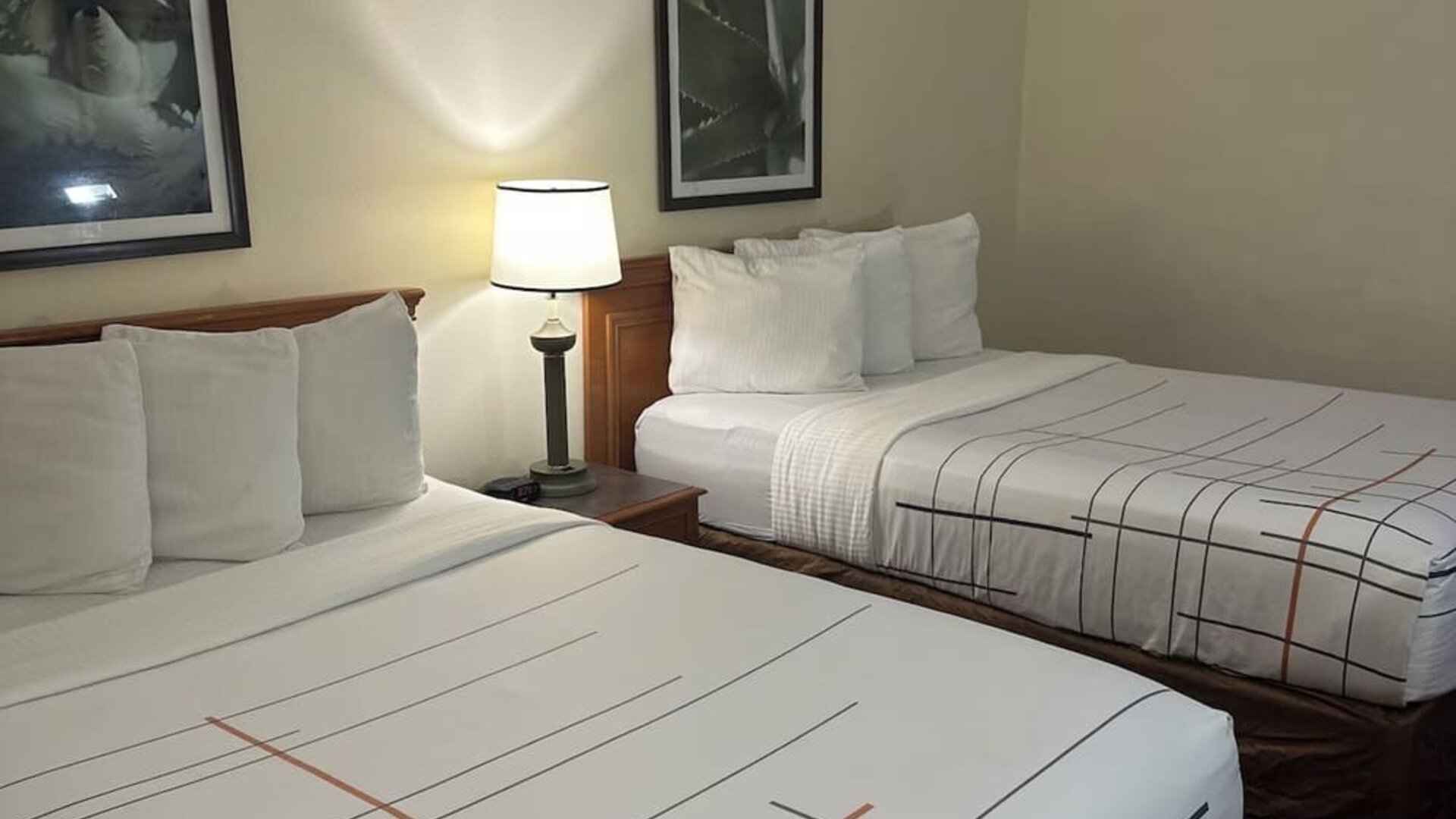 Guest room with two beds, comfortable furnishings, and practical amenities, making it an ideal accommodation choice for families or groups staying at La Quinta Inn & Suites By Wyndham Sawgrass Mills.