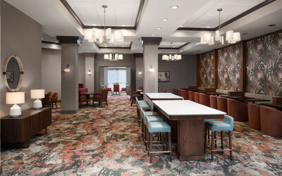 Hotel dining area featuring contemporary seating, open spaces, and a welcoming environment for guests at Embassy Suites By Hilton Charleston Airport Convention Center.