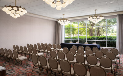 Conference and event space arranged in theater style, ideal for presentations, seminars, and corporate events at Embassy Suites By Hilton Charleston Airport Convention Center.