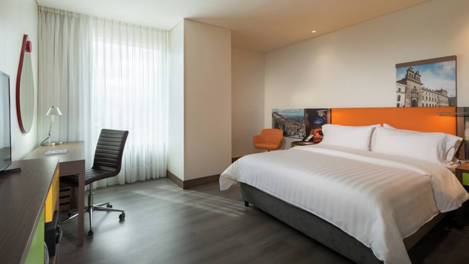 King bedroom with desk at the Hampton by Hilton Bogota Airport.