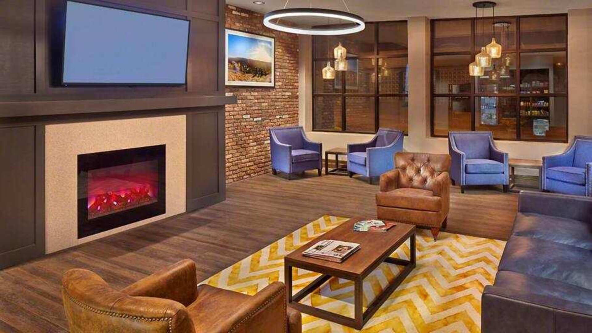 Lobby workspace by the fireplace at the Tapestry By Hilton Scholar Morgantown, WV.