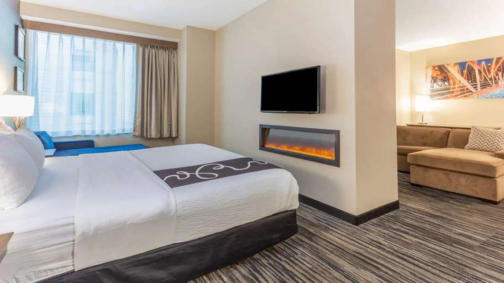 Hotel suite with fireplace and TV screen at La Quinta Inn & Suites By Wyndham Chicago Downtown.
