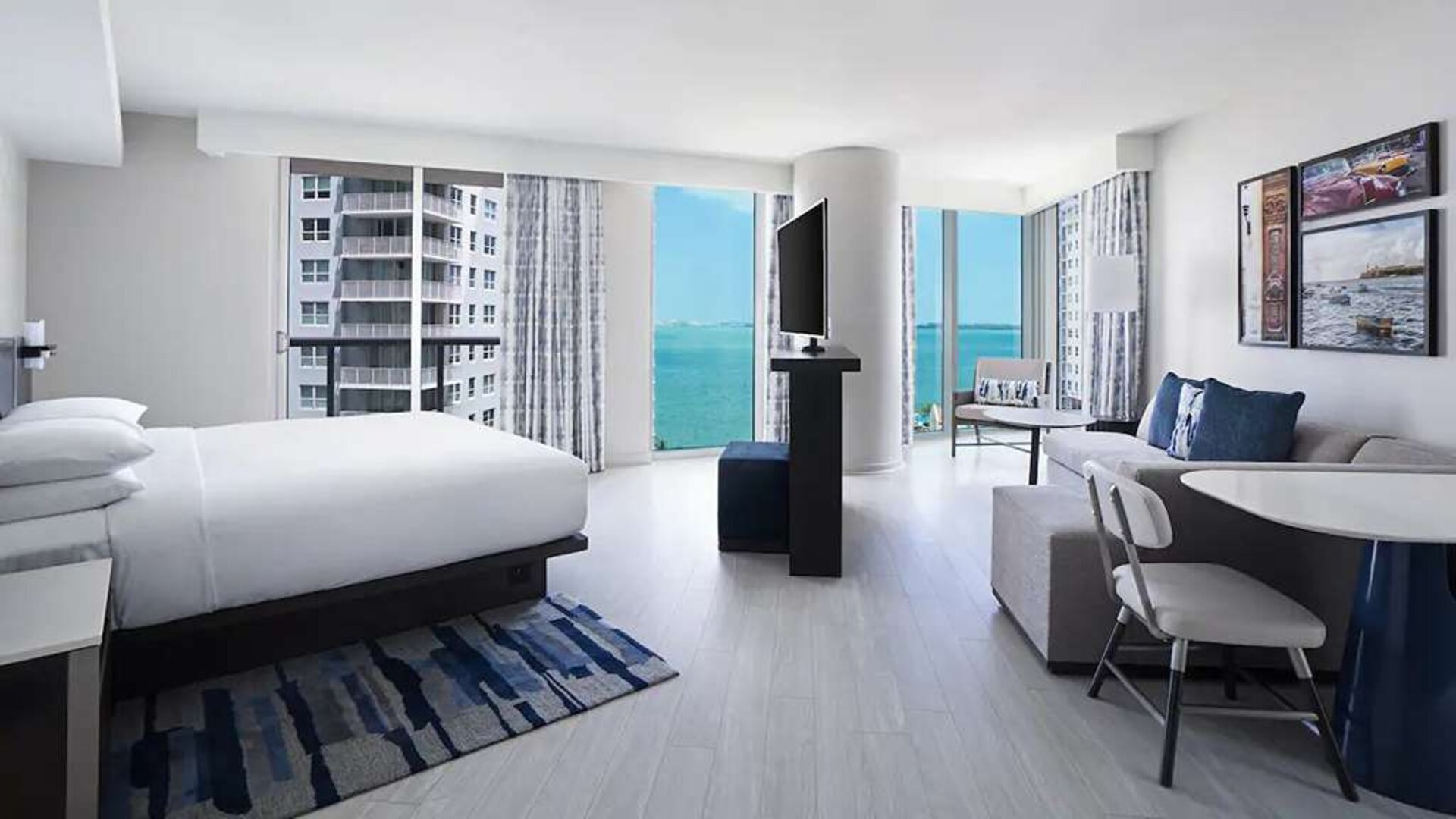 Hotel suite with TV screen, sofa and workstation at Hyatt Centric Brickell Miami.