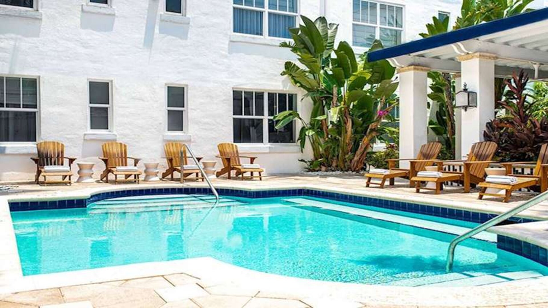 Outdoor pool with lounges at Blue Moon Hotel.