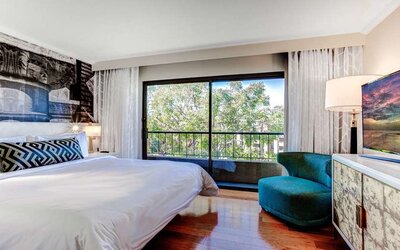 King bedroom with big window at Avenue Of The Arts Hotel.
