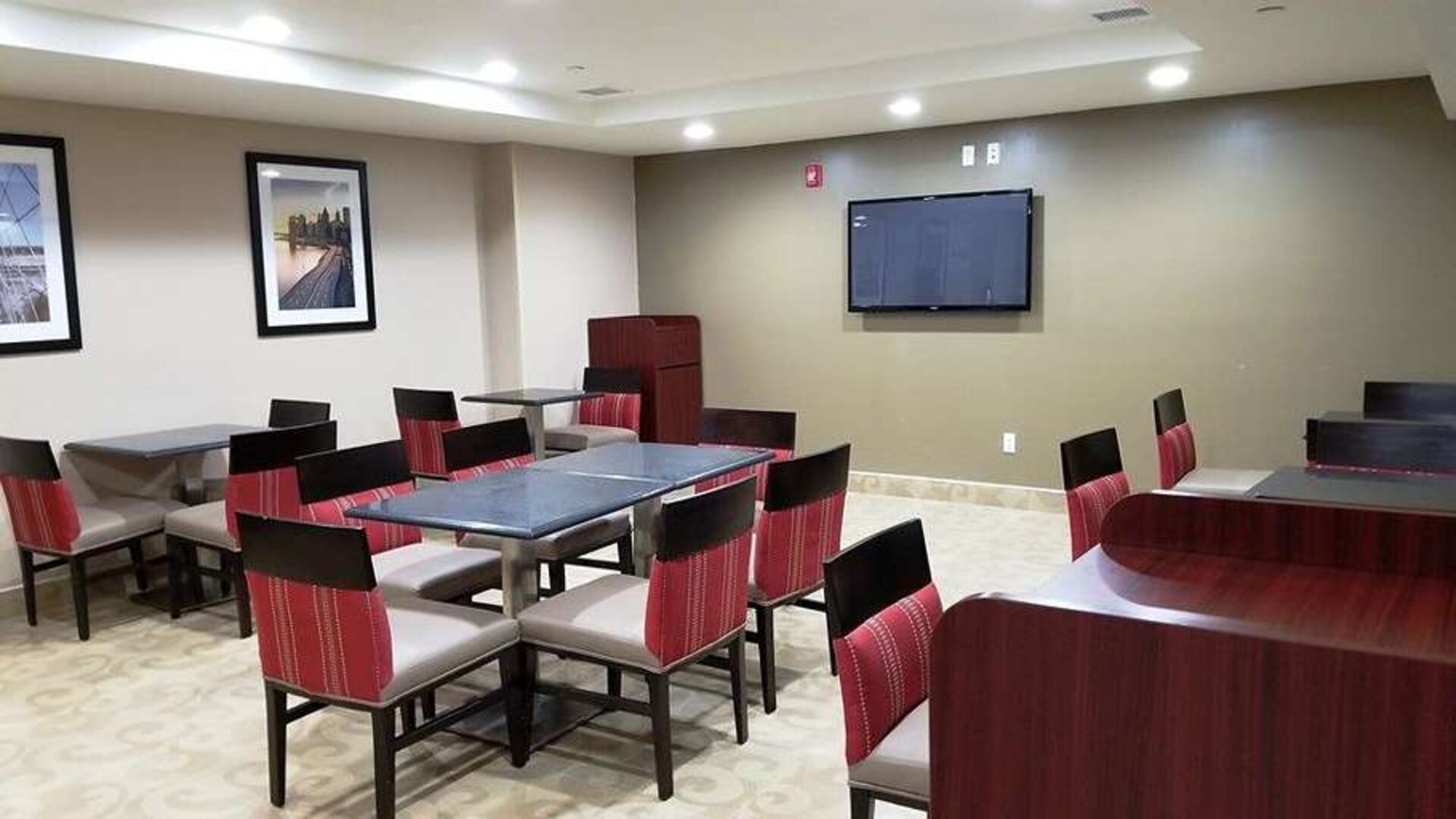 Seating area with TV screen at Days Inn Brooklyn Marine Park.
