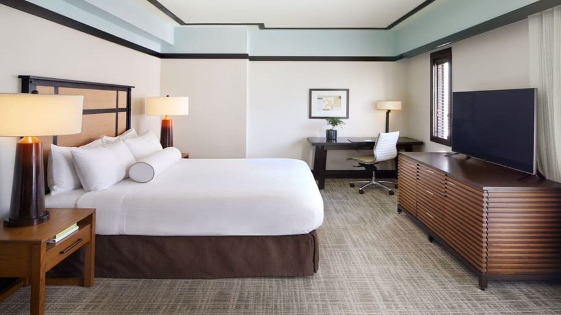 Spacious delux king room with TV and business desk at The Ambrose Hotel Santa Monica.