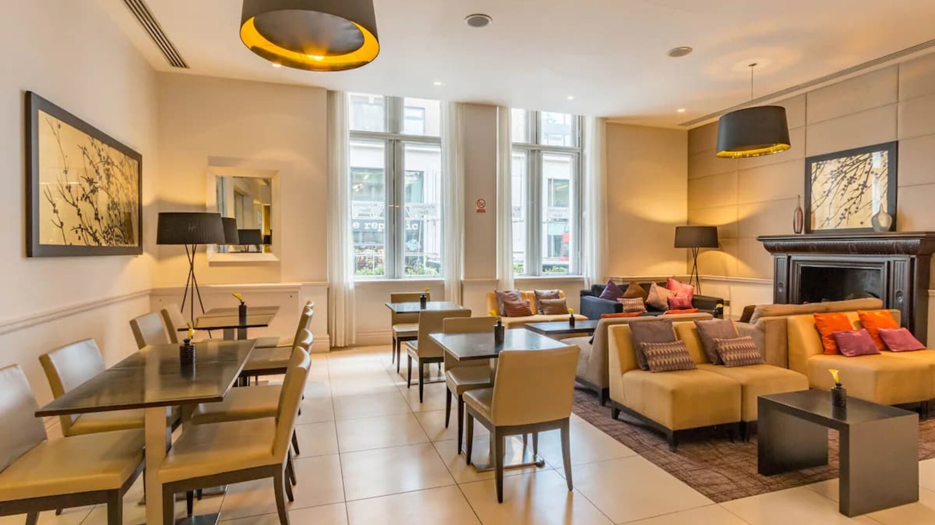 Several tables and upright chairs for laptop work as well as couches for more comfortable leisure sitting and meetings.