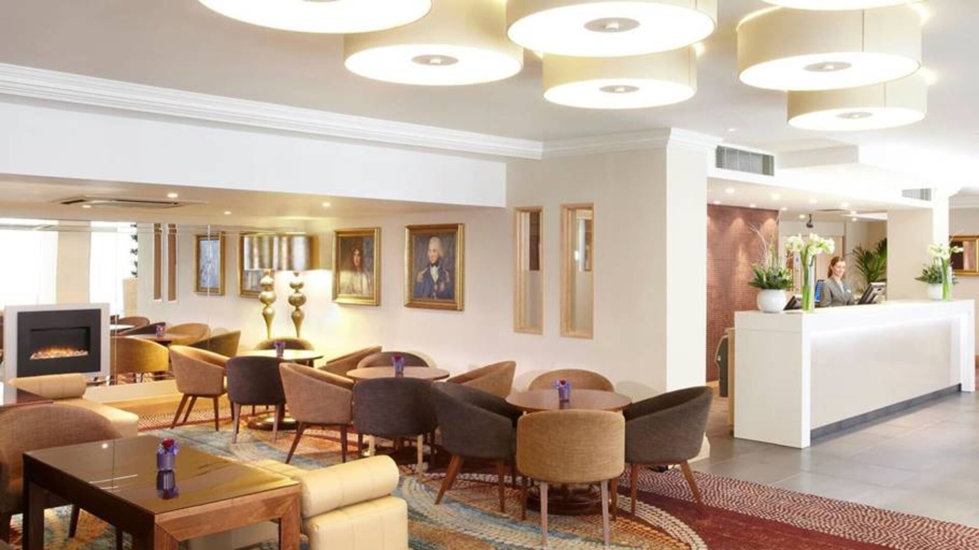 Comfy and communal seating with coffee tables near the hotel entrance.