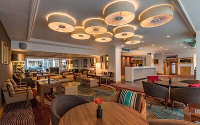 Multi-colored and eclectic chairs and tables fill a spacious lounge area.