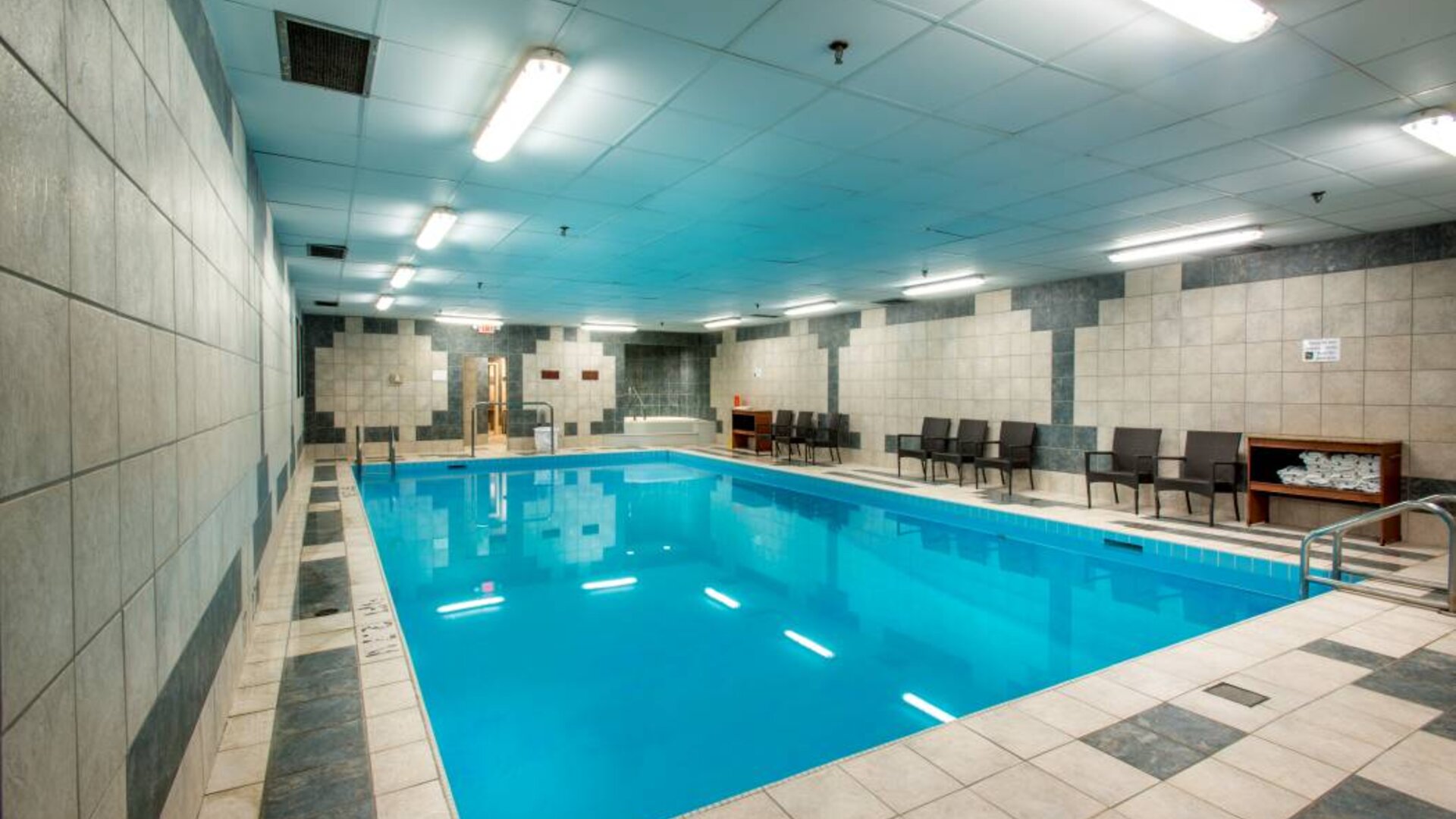 The hotel’s indoor pool has chairs and towels close at hand for swimmers.