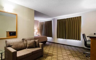Guest room in the Comfort Inn Saskatoon, with double bed and sofa.