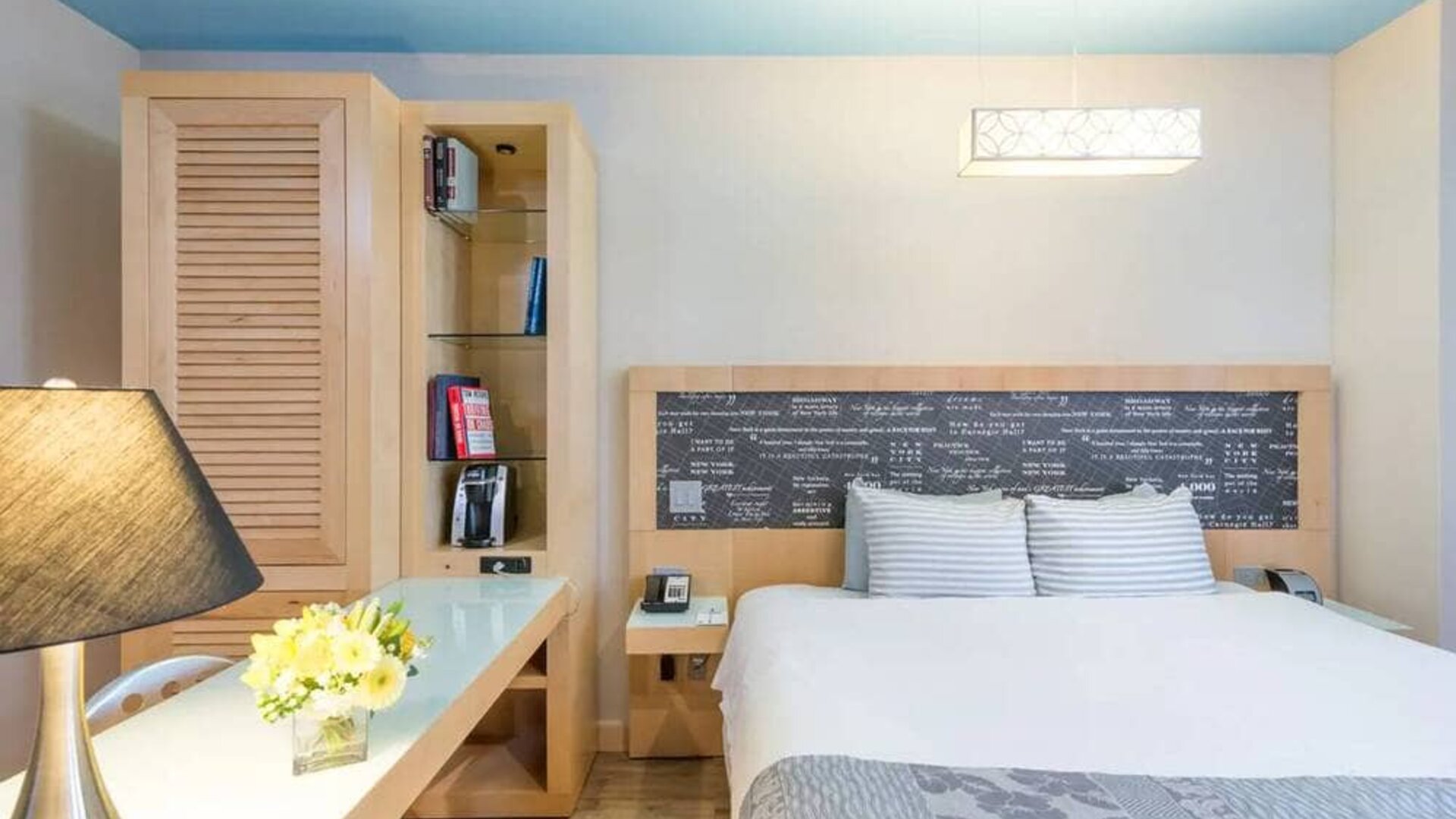 Double bedroom at TRYP By Wyndham Times Square South, including bookcase and lamp.