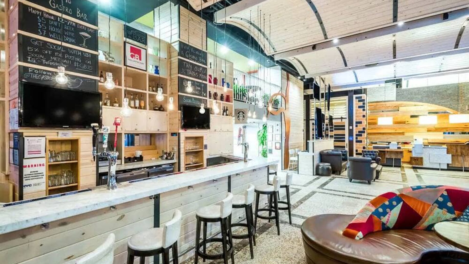 The Gastro Bar of TRYP By Wyndham Times Square South, with both bar stools and soft seats.