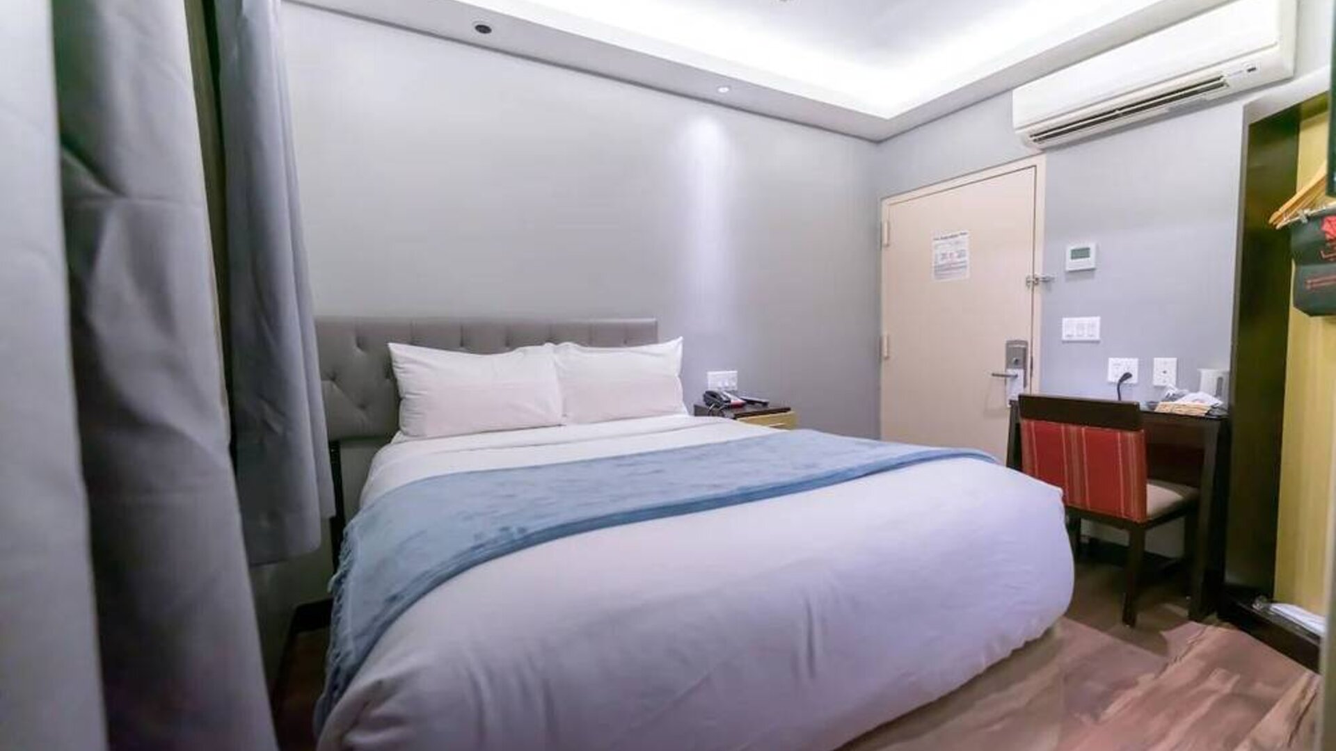 Madison LES Hotel room with double bed, and desk for working.