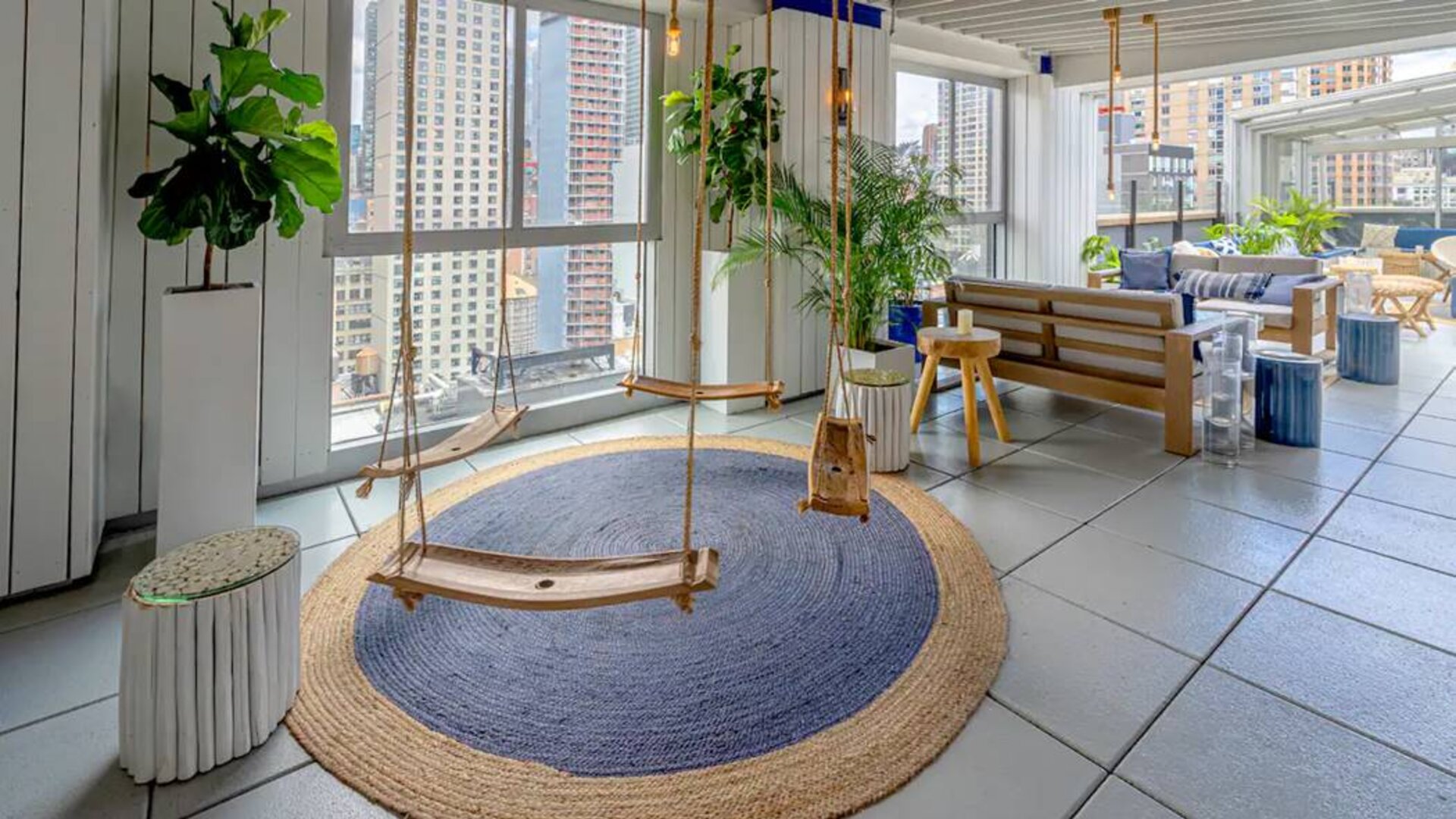 The Hilton Fashion District’s whimsical Sandbar Rooftop bar, including city views and swing seats.