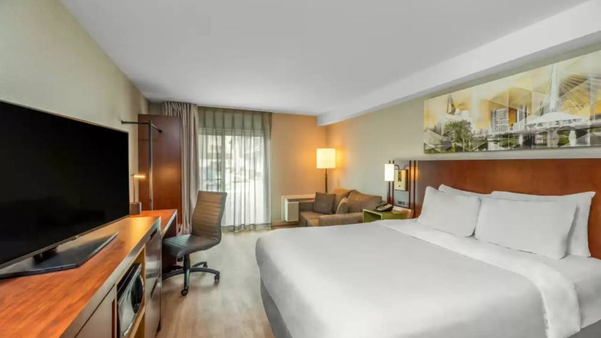 Comfort Inn Winnipeg Airport guest room including double bed and large television.