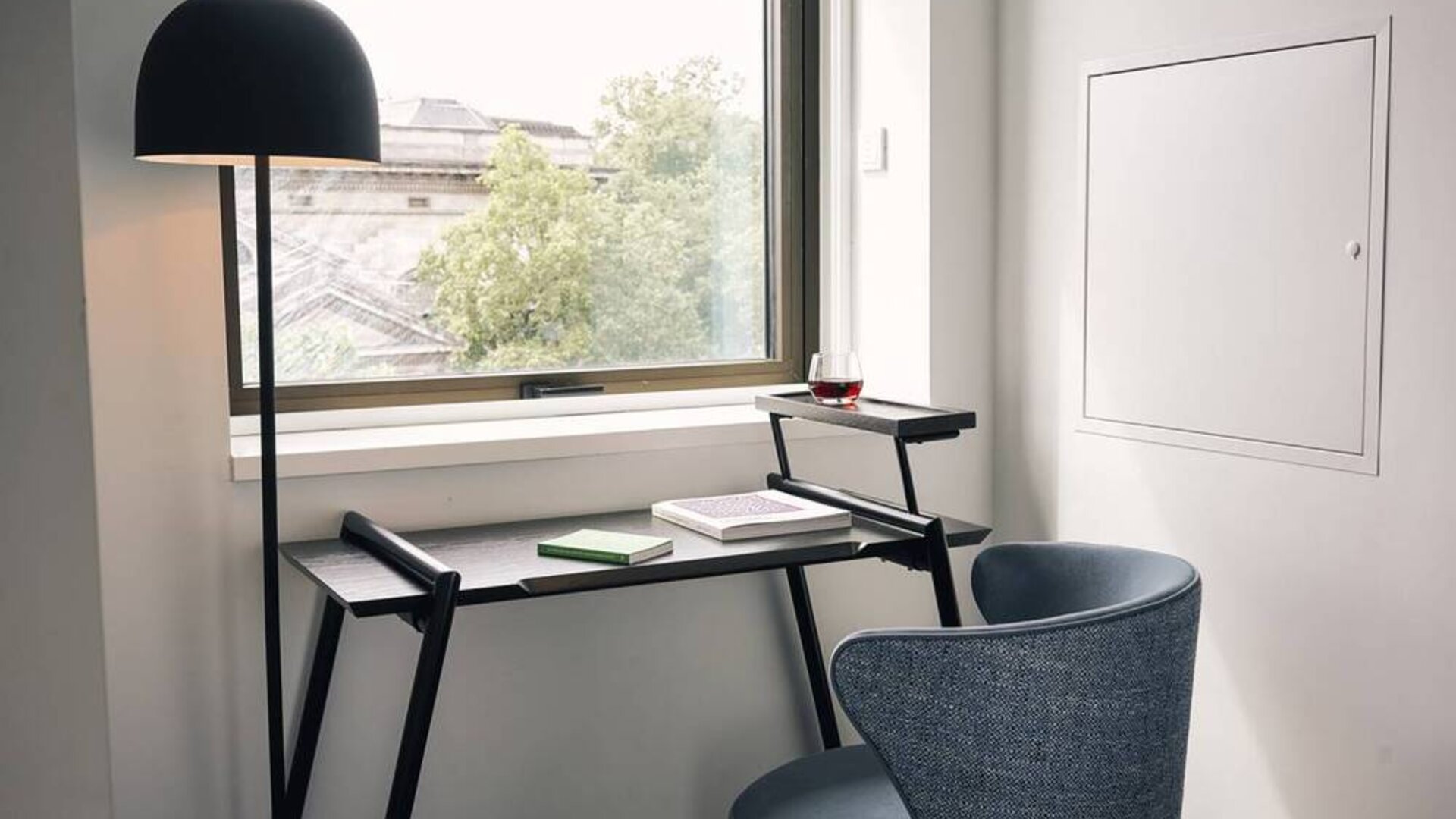 A little workspace, with desk, lamp, and window to ensure an abundance of light.