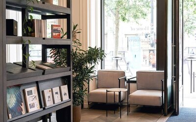 The Page Common Coffeehouse of Page8, Page Hotels with large windows and comfy seating for social discourse.