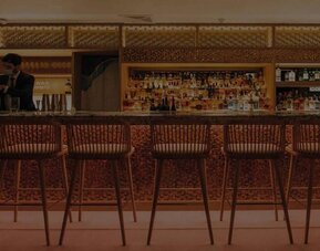 The hotel’s on-site Japanese restaurant, located on the roof, with tall bar stools and omakase-style dining.