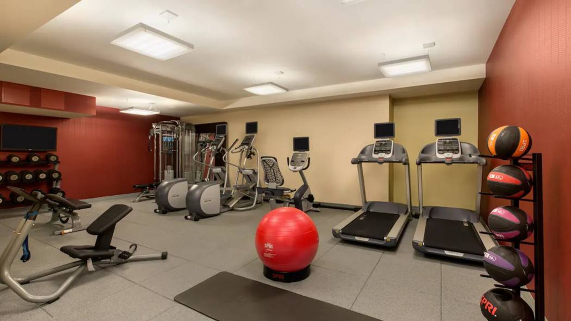 The hotel fitness center where guests can use exercise machines, balls, and weights.