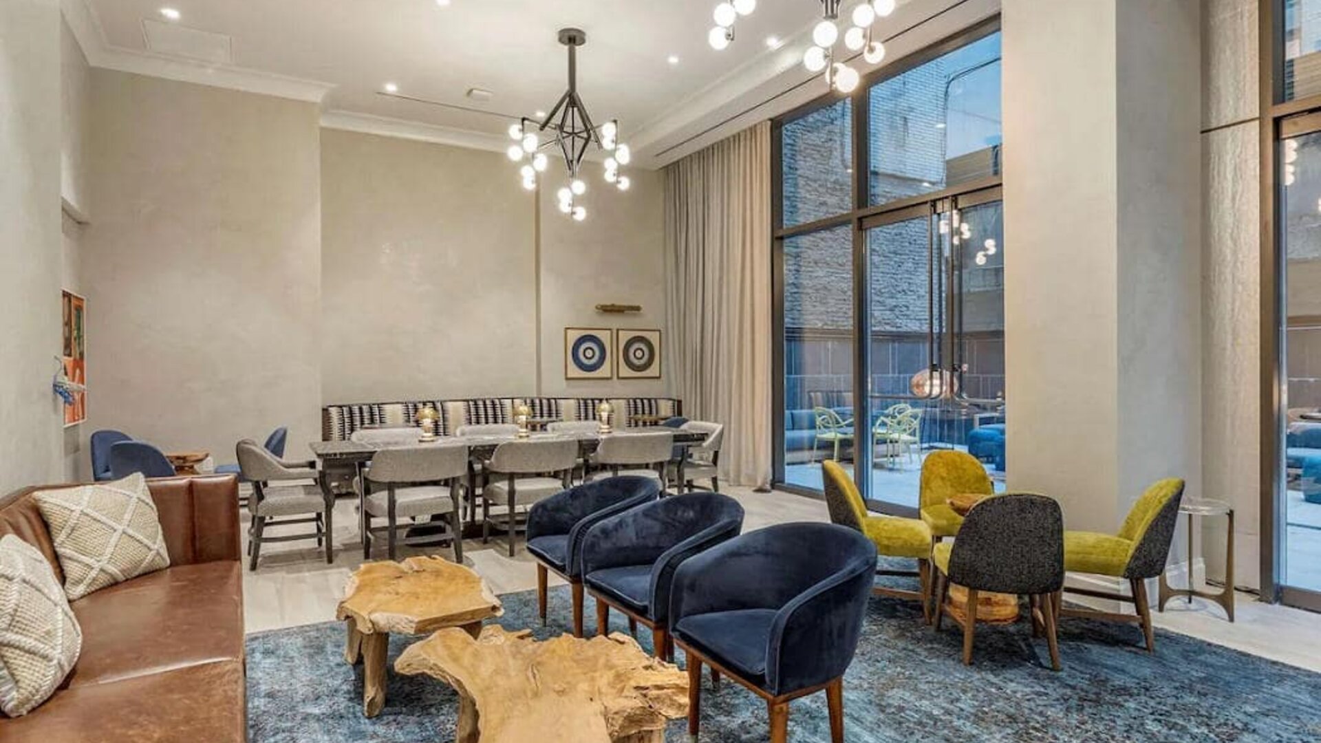 Lounge in the lobby of The Draper, Ascend Hotel Collection, with sofas, comfy chairs, and tables.