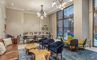 Lounge in the lobby of The Draper, Ascend Hotel Collection, with sofas, comfy chairs, and tables.