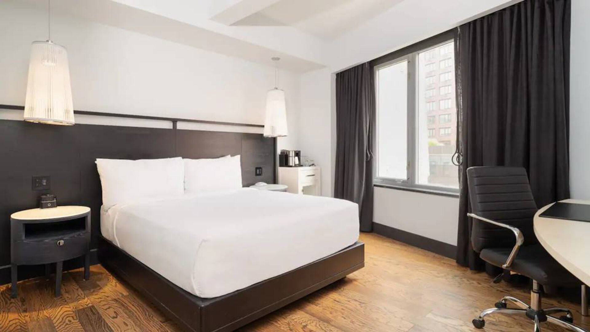 Guest room in the Hyatt Union Square New York, with large bed, window, and workspace.