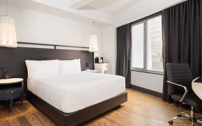 Guest room in the Hyatt Union Square New York, with large bed, window, and workspace.
