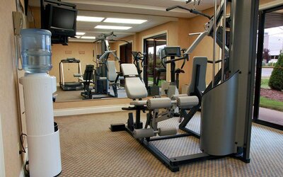 Comfort Inn Fredericton’s fitness center has multiple exercise machines and an overhead TV.