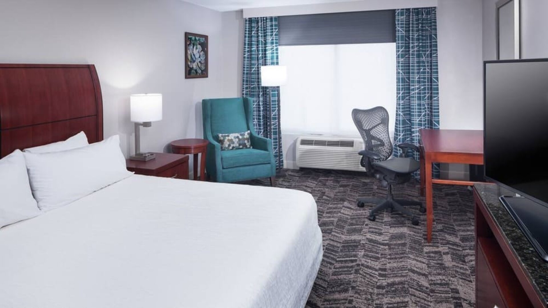 Spacious king suite with TV and business desk at Hilton Garden Inn Dallas/Allen.