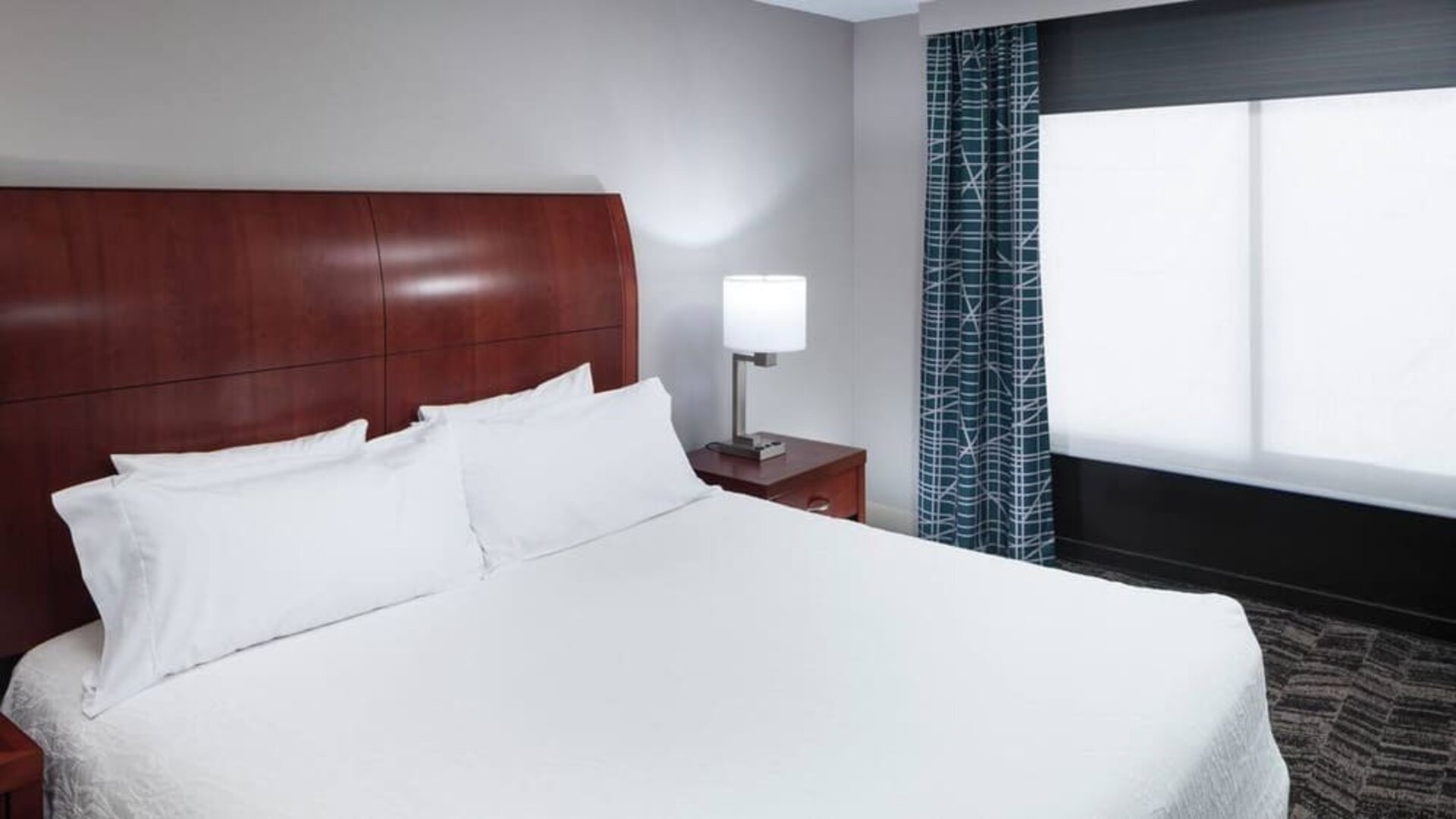 Comfortable king bedroom with natural light at Hilton Garden Inn Dallas/Allen.