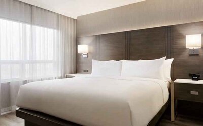 King size bed in a king suite at the Embassy Suites by Hilton Toronto Airport.