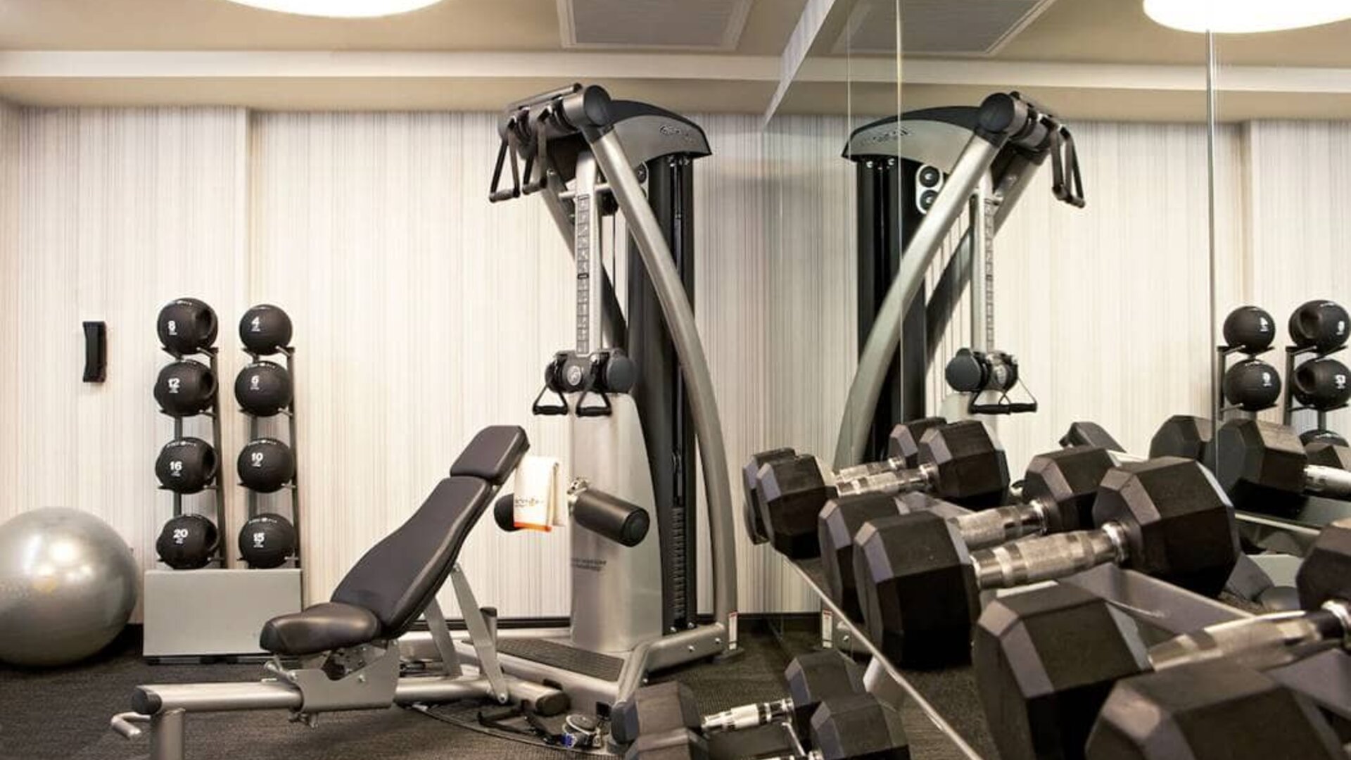 The Hotel 48LEX New York’s fitness center, with weights and exercise machinery.