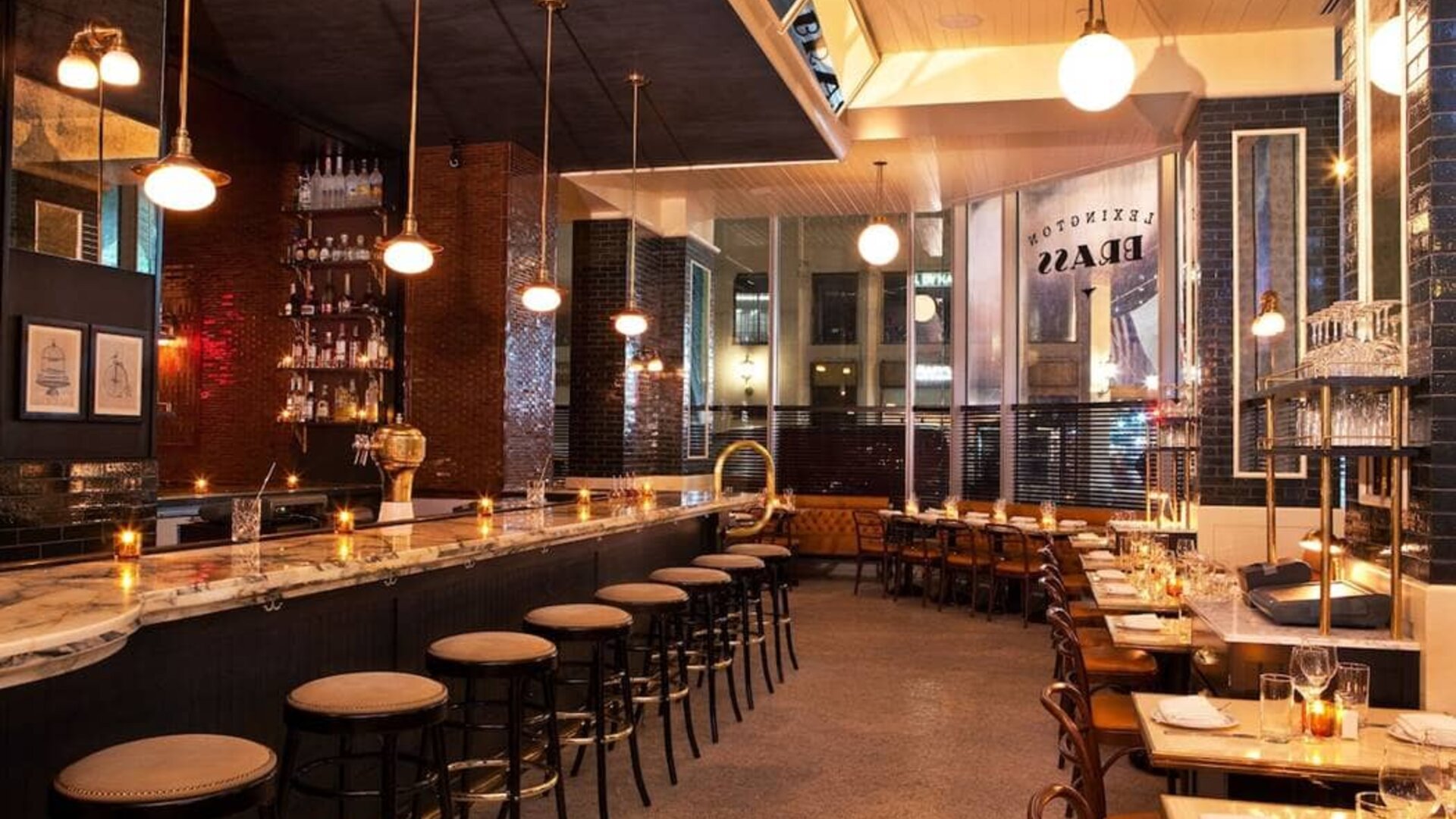 Hotel 48LEX New York’s bar and restaurant, with small tables and tall bar stools.