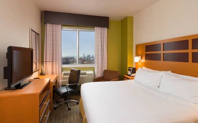 Guest room of the Holiday Inn Express Times Square, with double bed, window, TV, and desk.