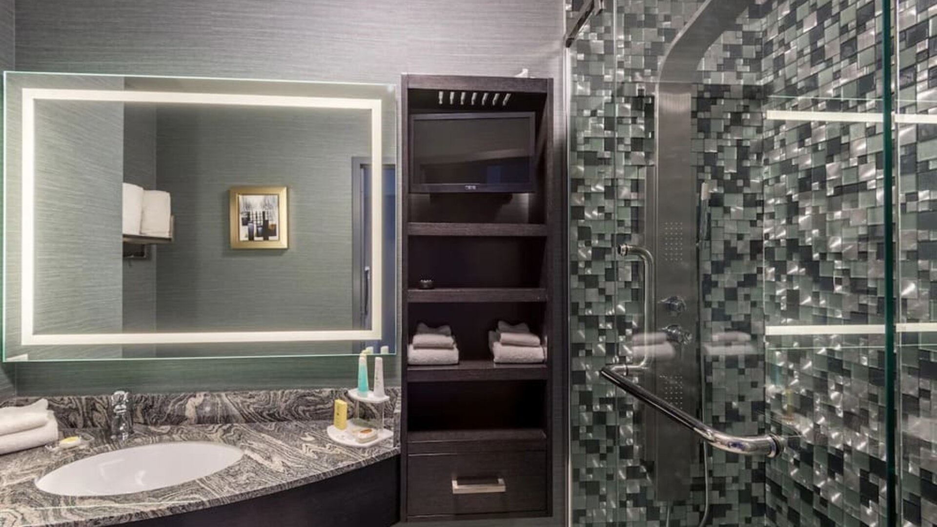 Spacious guest bathroom with shower at Hotel Clique Calgary Airport.