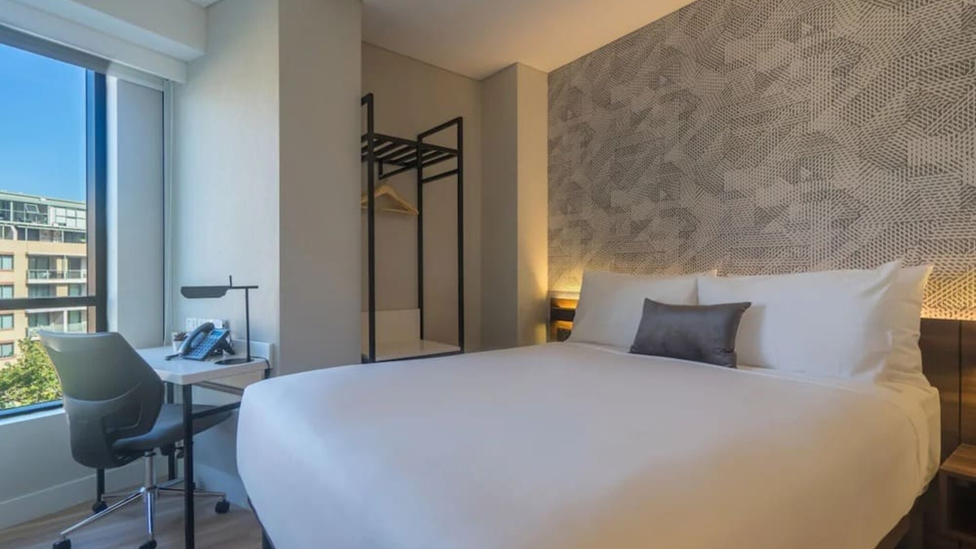 King bedroom with work space and natural light at Hotel Kith.