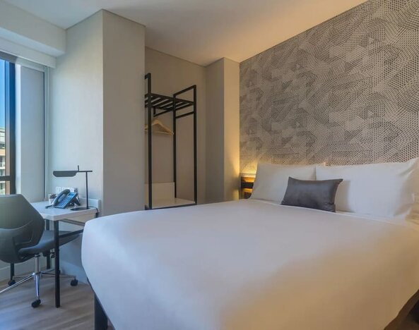 King bedroom with work space and natural light at Hotel Kith.