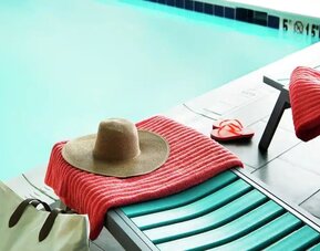 Lovely pool area with seating at Home2 Suites By Hilton Dallas Medical District Lovefield.
