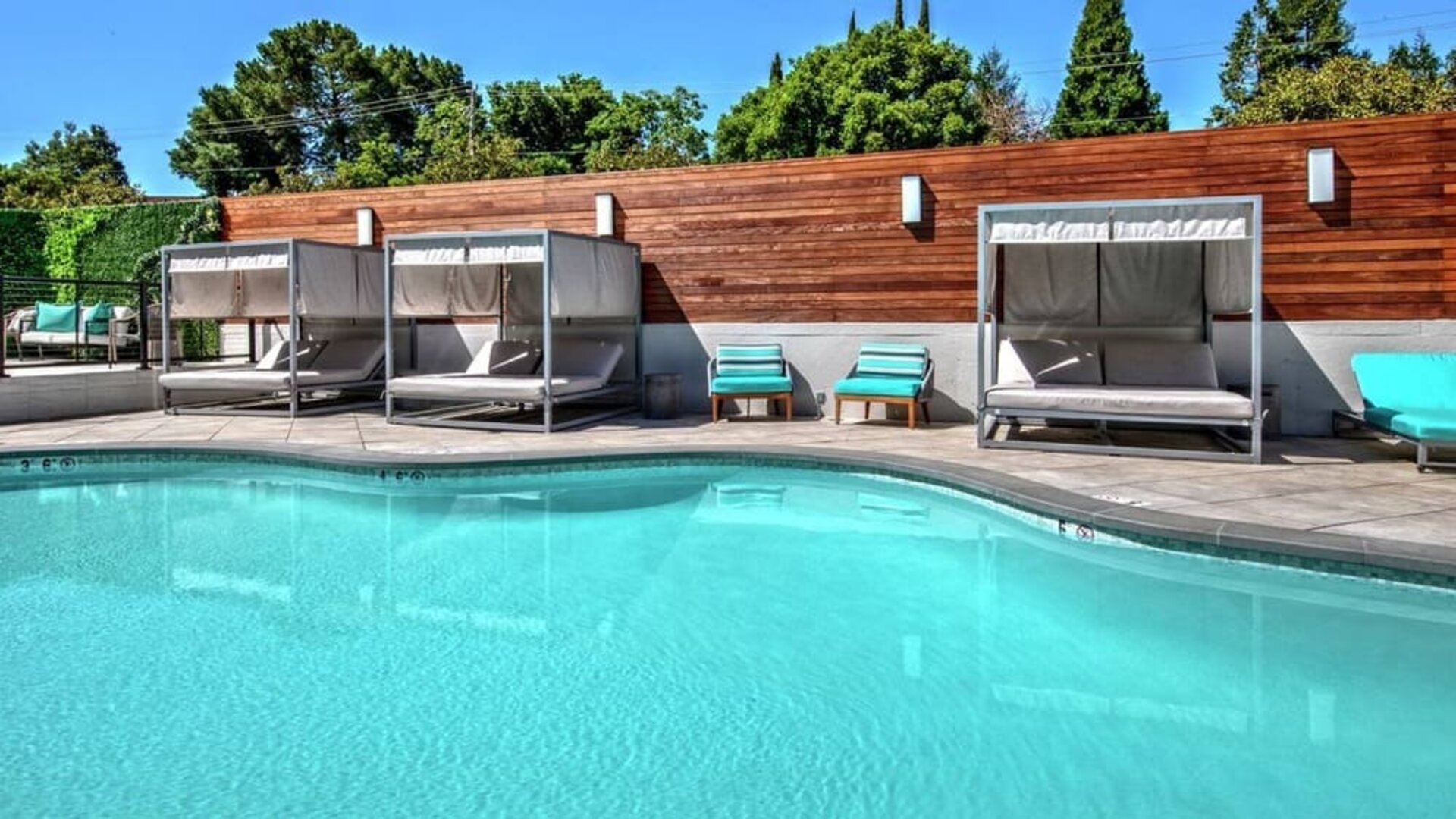 Relaxing pool area with cabanas at Hampton Inn Vallejo.