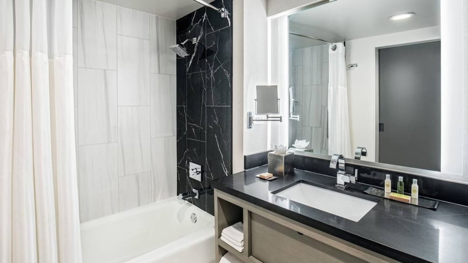 Private guest bathroom with shower and tub at DoubleTree By Hilton Washington DC North/Gaithersburg.