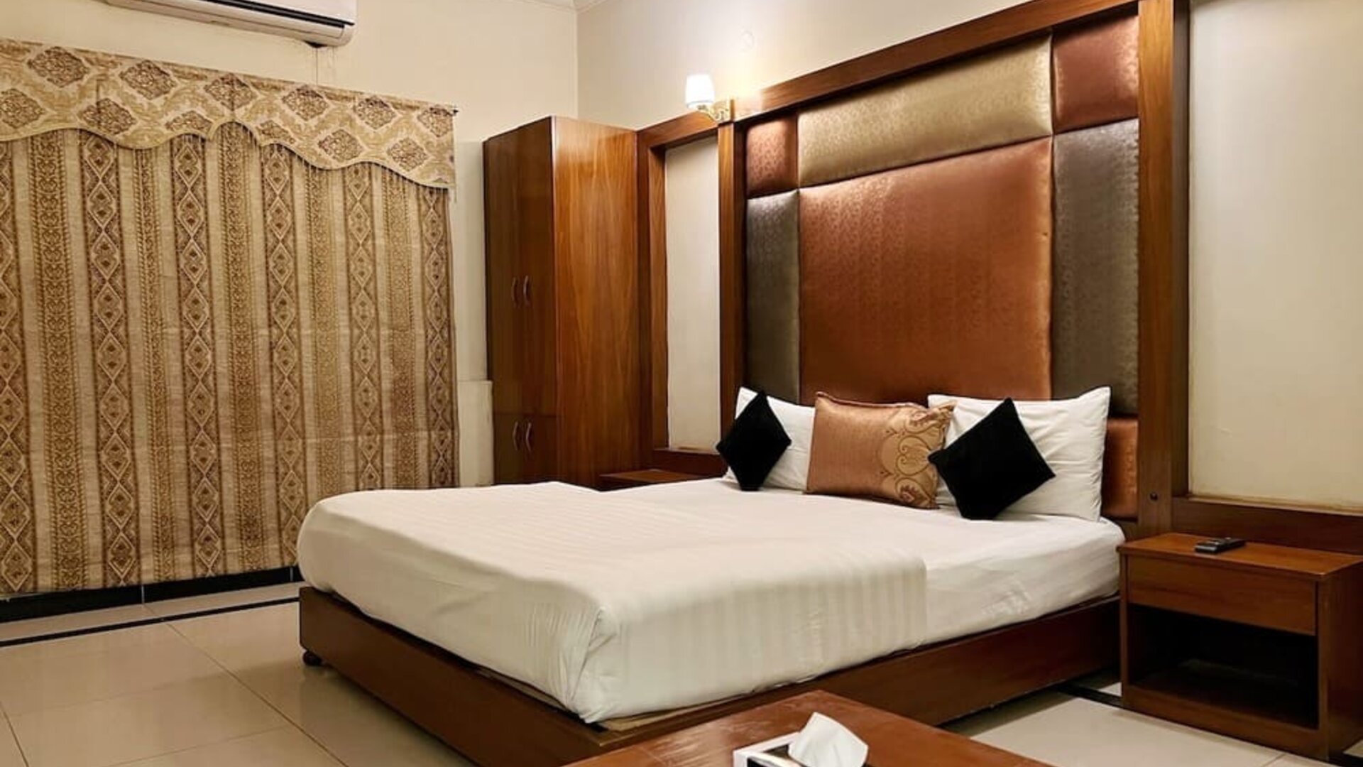 King bedroom with air conditioning at The Grand Hotel Multan.