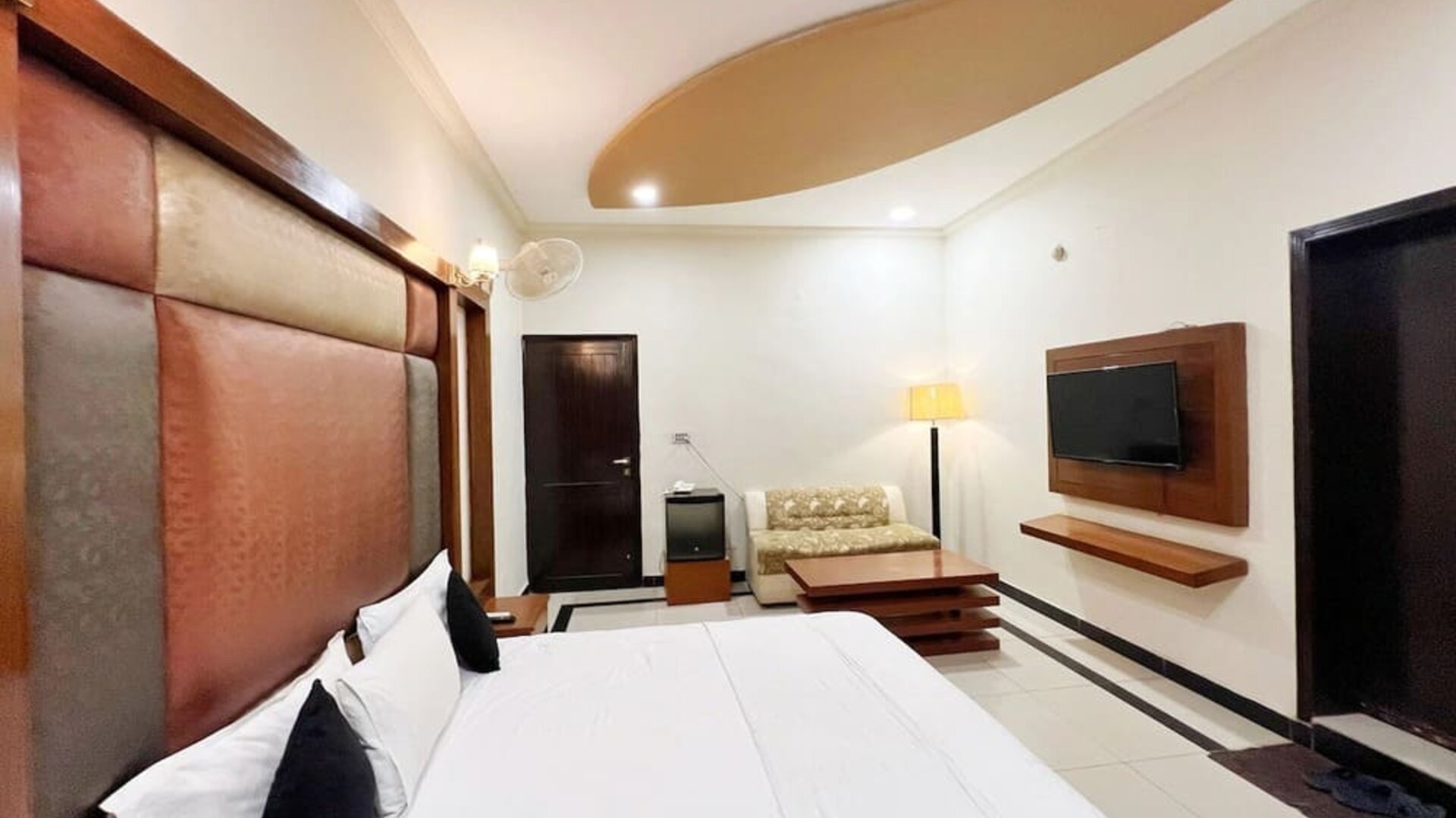 Day room with TV at The Grand Hotel Multan.