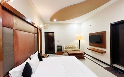 Day room with TV at The Grand Hotel Multan.