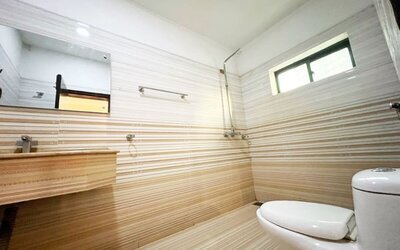 Private guest bathroom with shower at The Grand Hotel Multan.