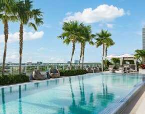 Relaxing pool area with sun chairs at The Altair Hotel Bay Harbor.
