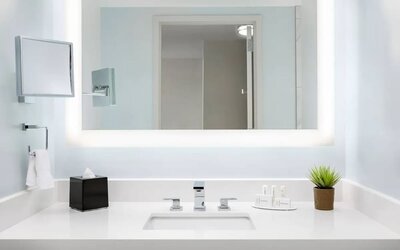 Well-lit guest bathroom with shower at Courtyard Boston Cambridge.