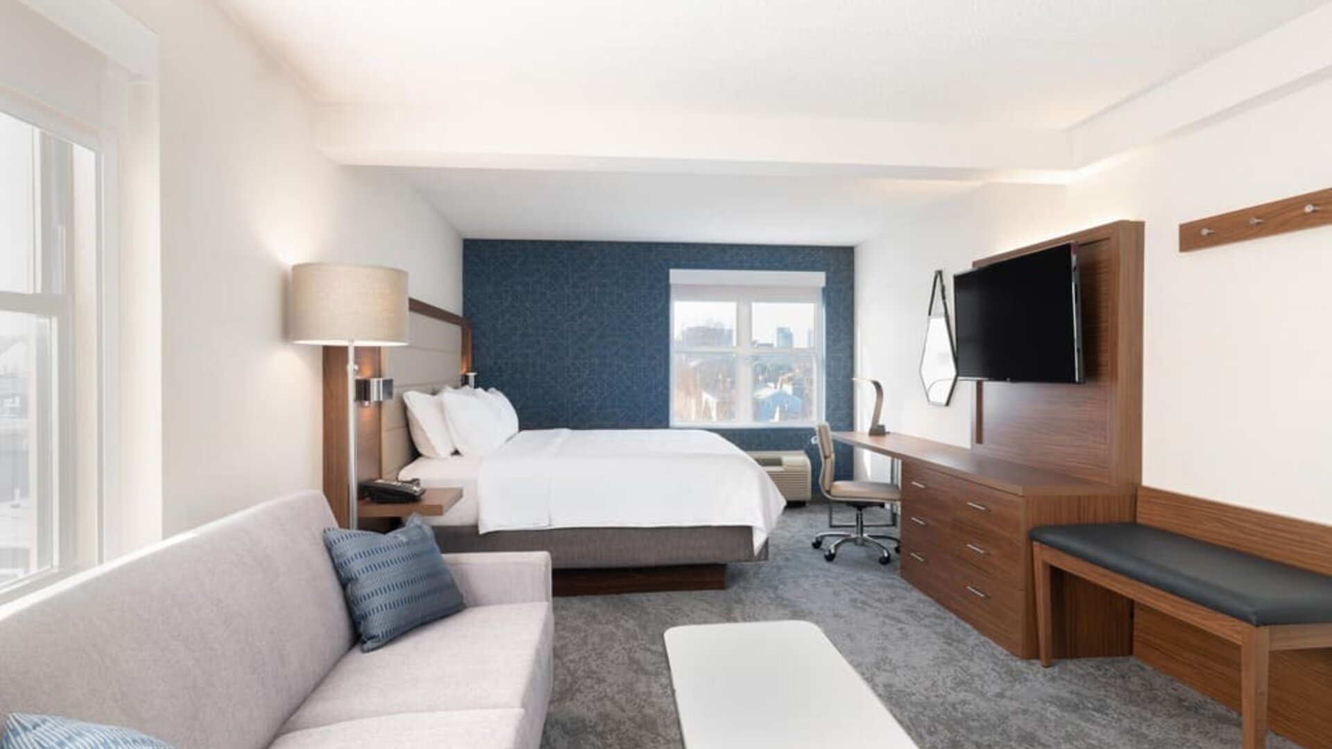 King bed with TV and business desk at Holiday Inn Express & Suites Boston-Cambridge.
